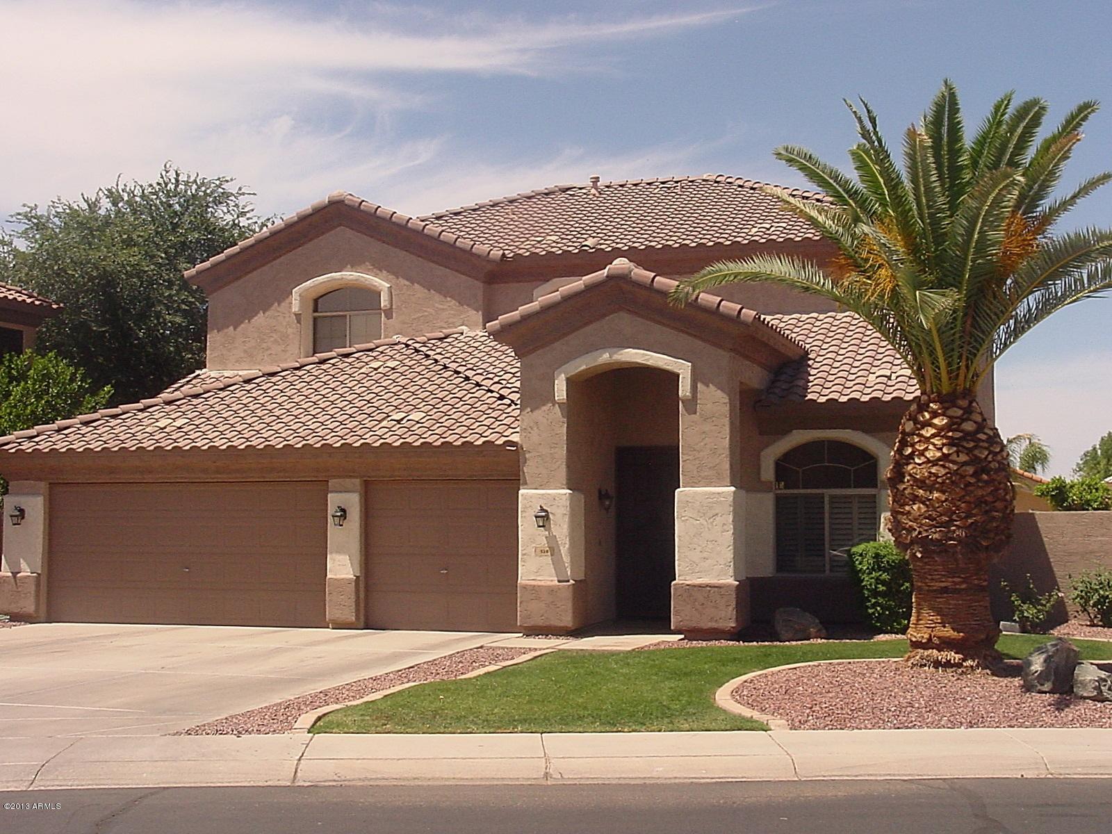 528 East Ranch Road Gilbert, AZ 85296 - Photo 1 of 42 a front view of a house with a yard and garage