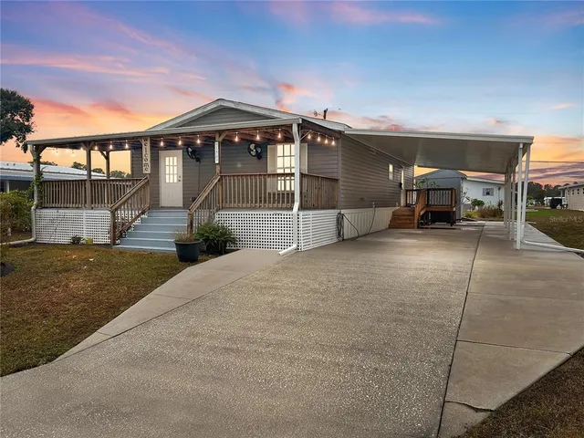 a view of a house with a yard and sitting area