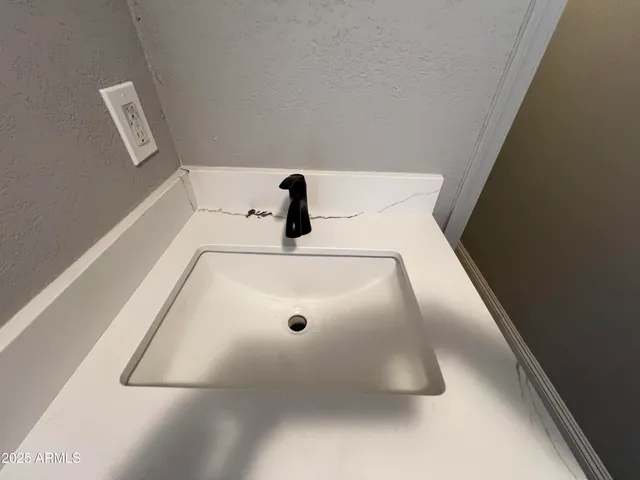 a room with a sink wooden floor and view living room