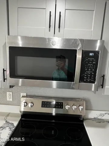 a stove top oven sitting inside of a kitchen