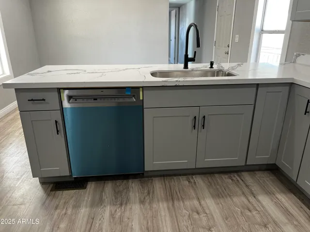 a kitchen with kitchen island sink and center island