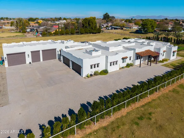 an aerial view of residential houses with outdoor space and ocean view