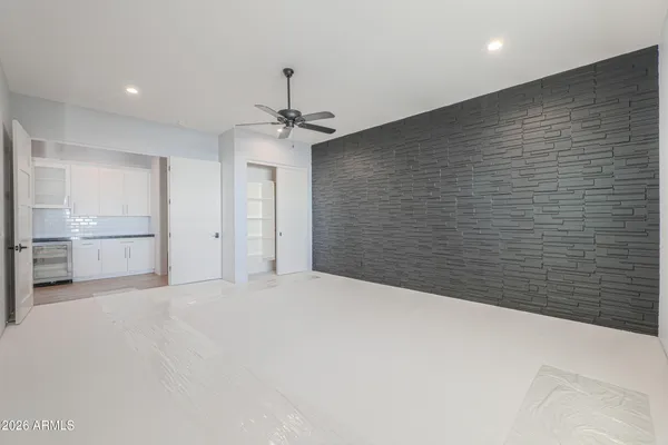 a spacious bathroom with a granite countertop sink a mirror and a shower