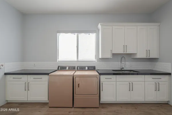 a spacious bathroom with a granite countertop sink mirror and a shower