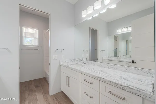 a view of a patio with table and chairs with wooden floor and fence