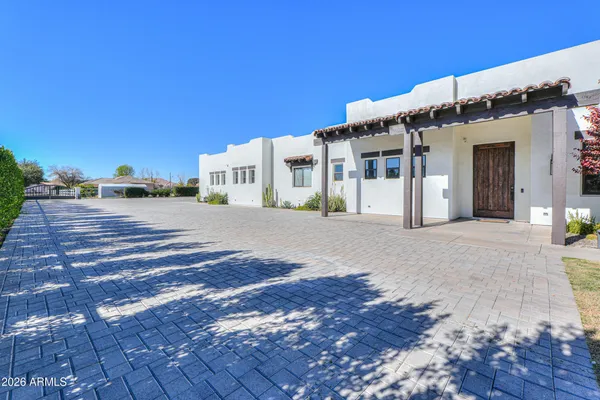 a view of a patio with a table and chairs under an umbrella