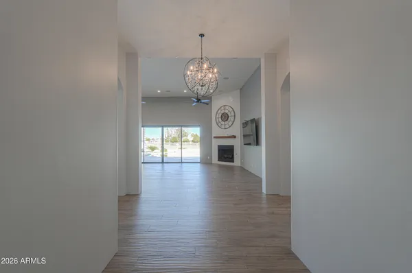 a large kitchen with a large counter top a sink stainless steel appliances and cabinets