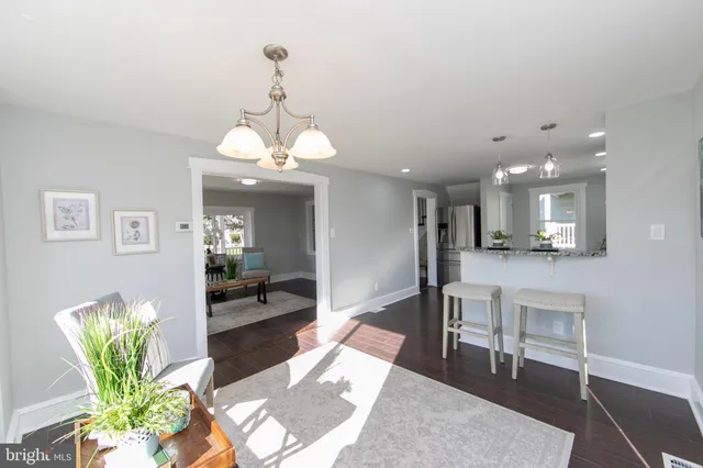 a view of a dining room with furniture and a chandelier