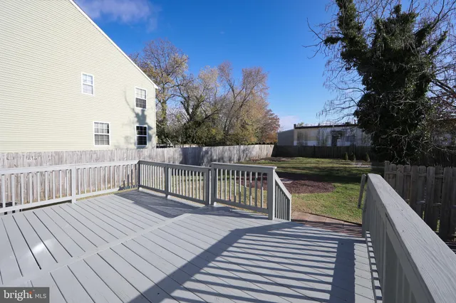 a view of balcony with wooden floor and fence