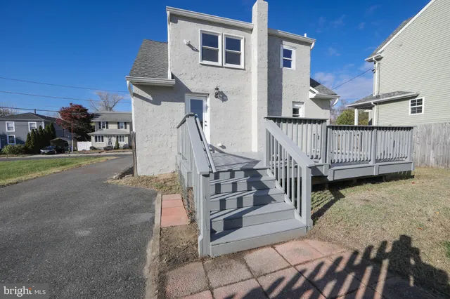 a view of a house with wooden floor fence and a yard