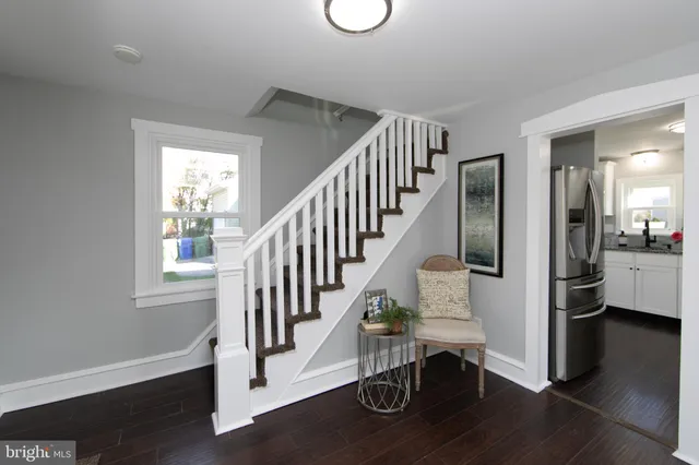 a view of entryway and hall with wooden floor