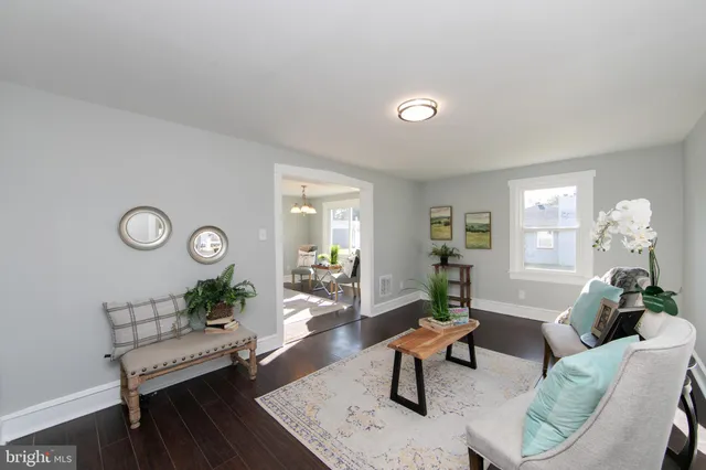 a living room with furniture a rug and a large window