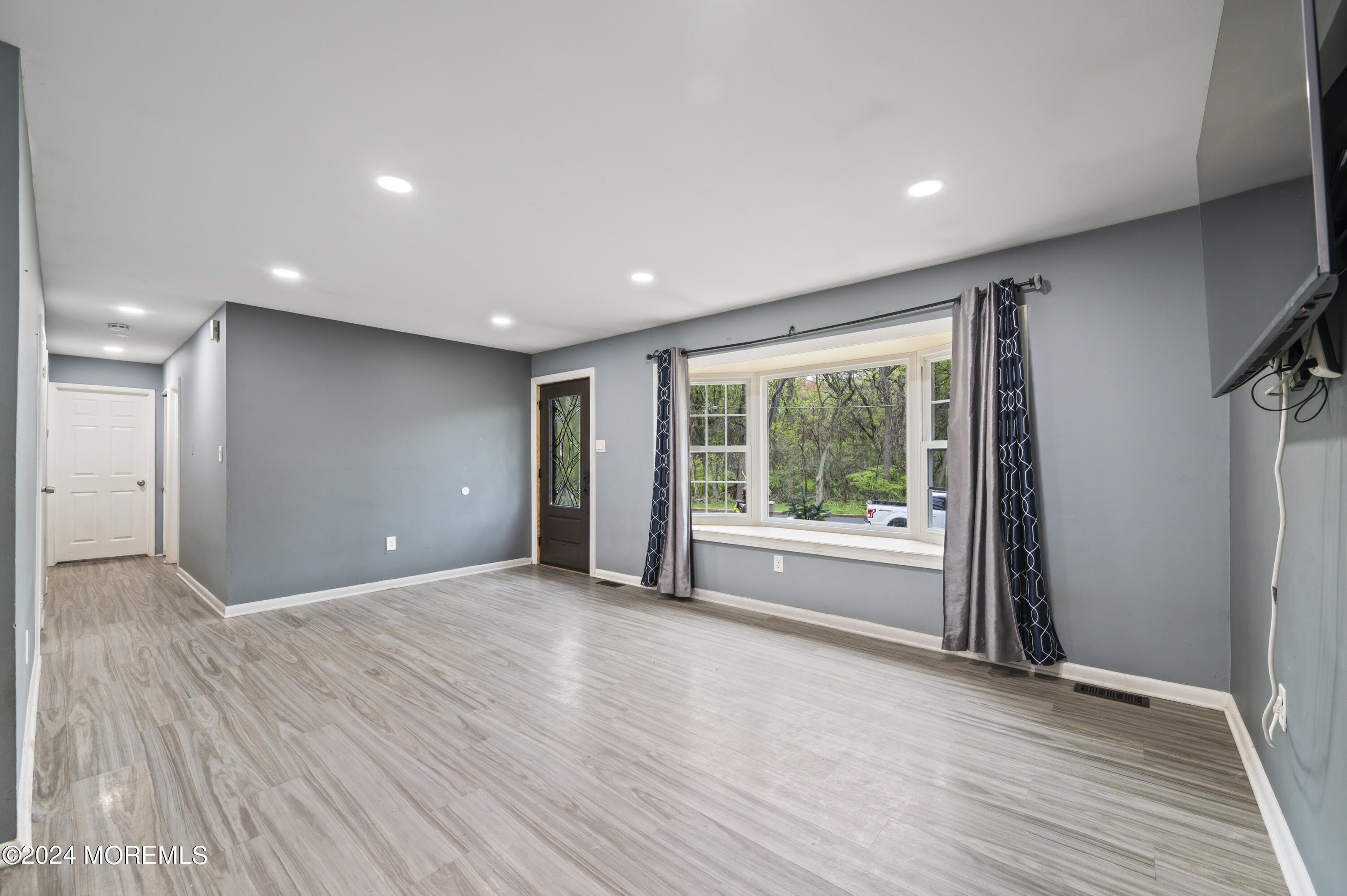 201 Hollowbrook Drive Ewing, NJ 08638 - Photo 9 of 44 a view of an empty room with a window and wooden floor