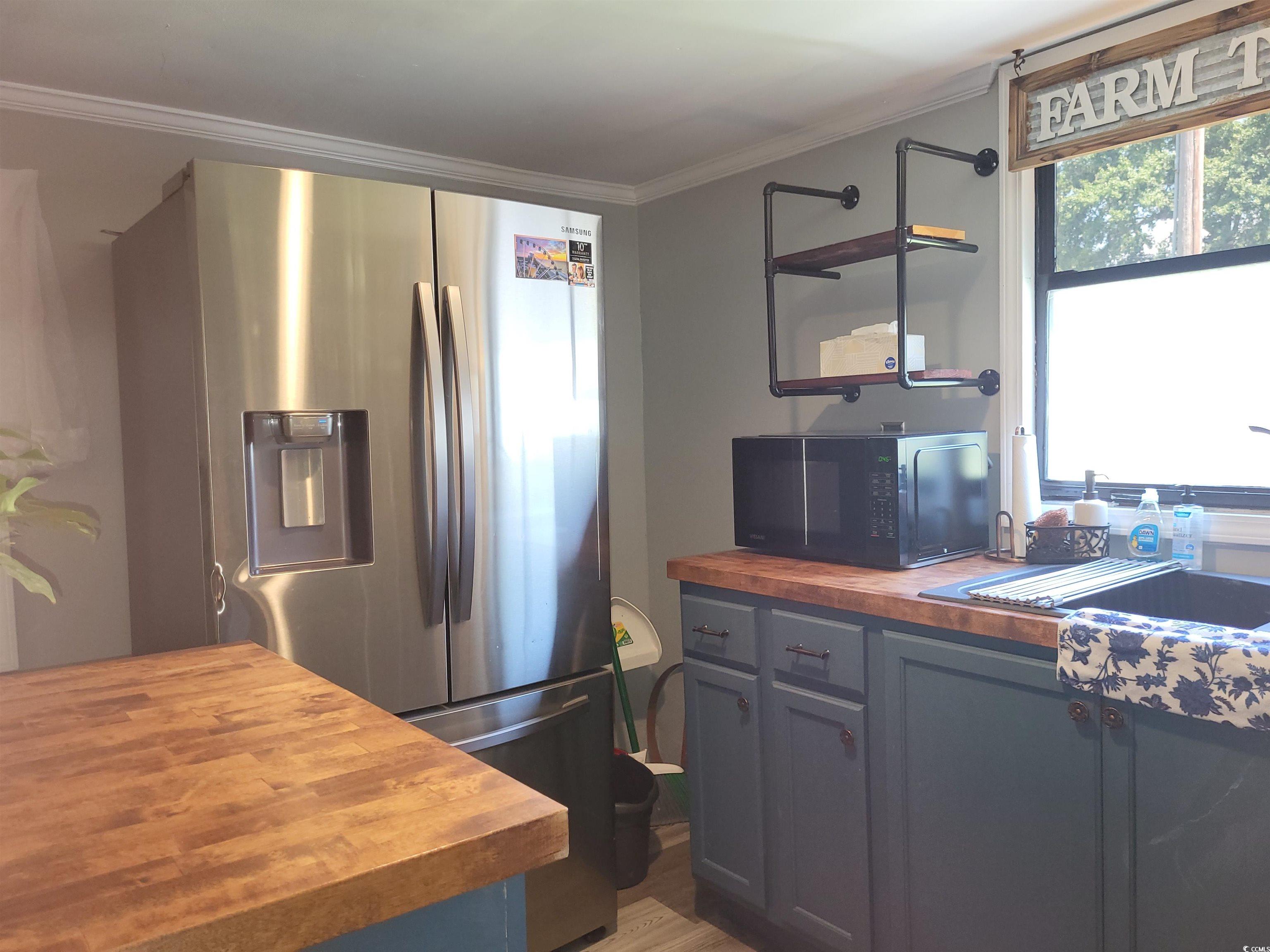 180 Offshore Drive Murrells Inlet, SC 29576 - Photo 4 of 23 Kitchen featuring wood counters, crown molding, ha