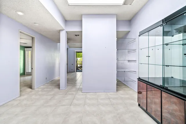 an empty room with wooden floor and cabinet
