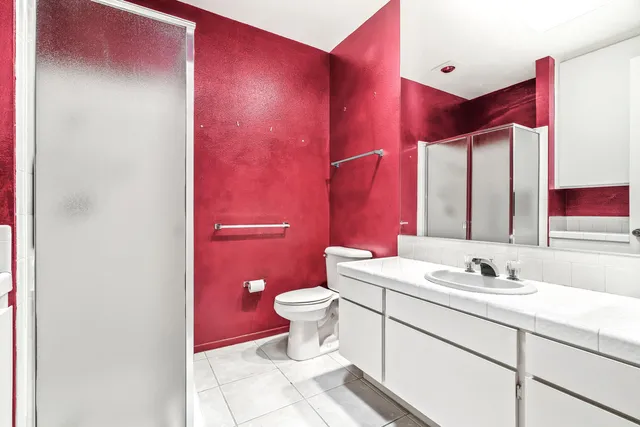 a bathroom with a sink mirror vanity and toilet