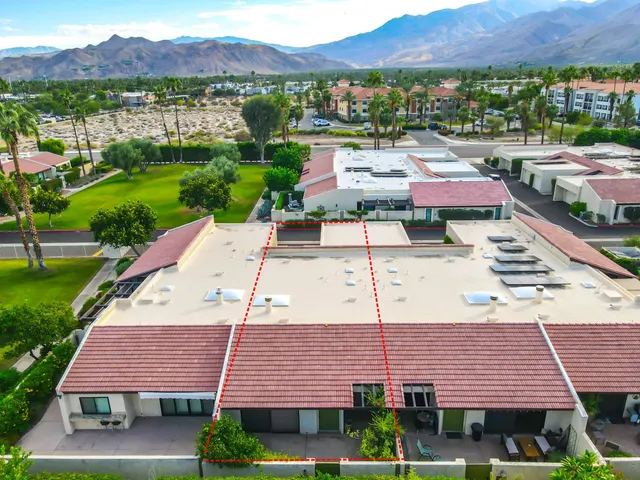 an aerial view of a house with a garden and lake view