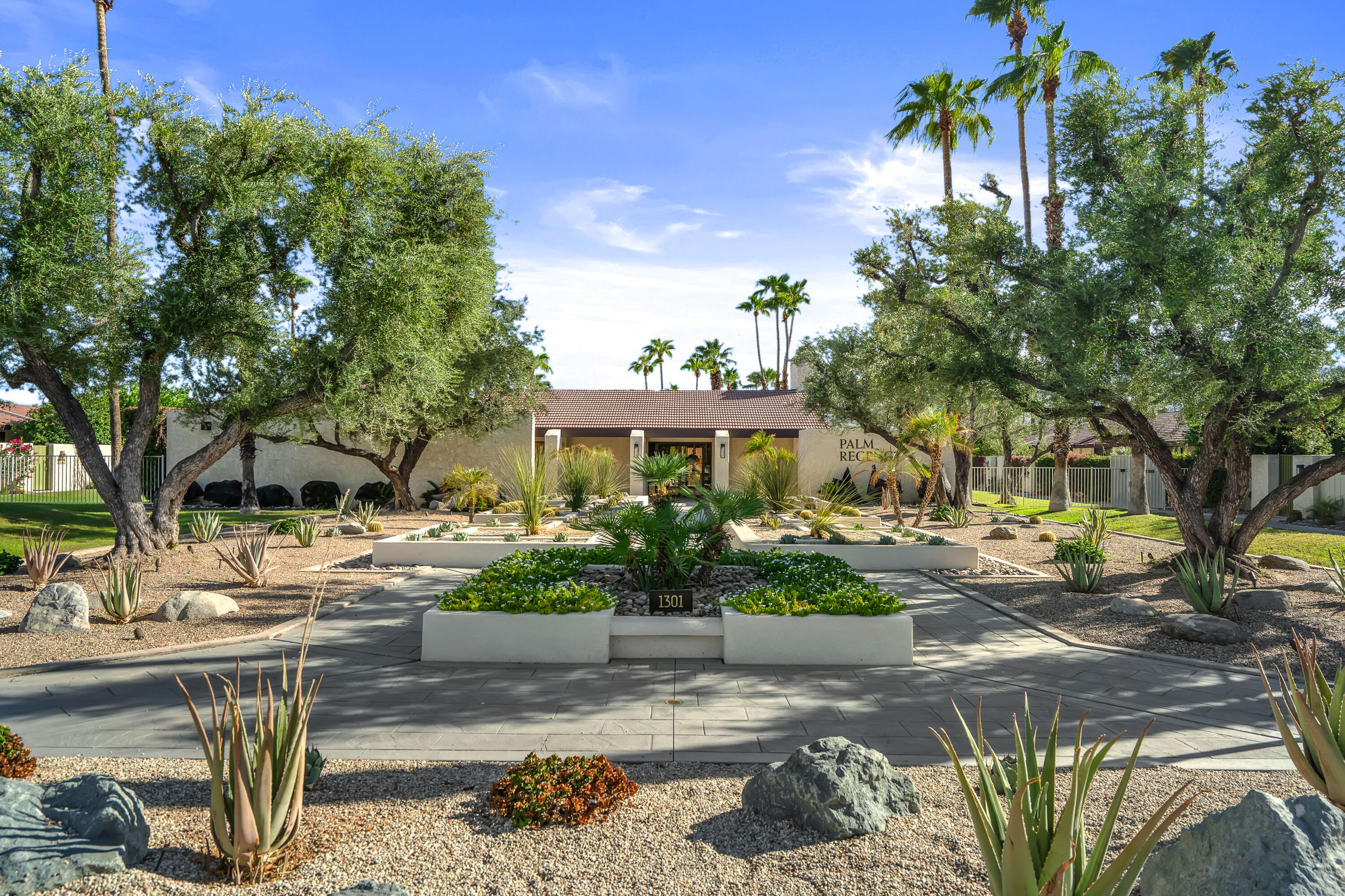 1384 East Andreas Road Palm Springs, CA 92262 - Photo 41 of 46 a view of a garden with a bench and potted plants