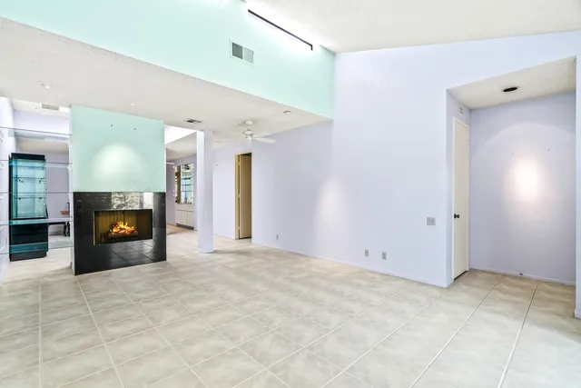 a view of an empty room with a fireplace