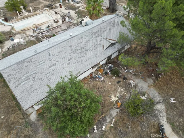 an aerial view of a houses with a yard