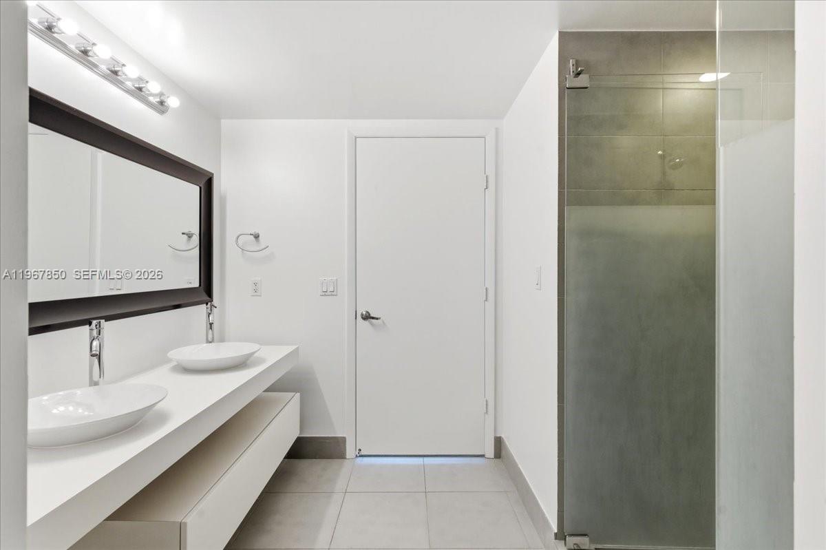 92 Southwest 3rd Street, Unit 3804 Miami, FL 33130 - Photo 20 of 36 a bathroom with a double vanity sink and a mirror