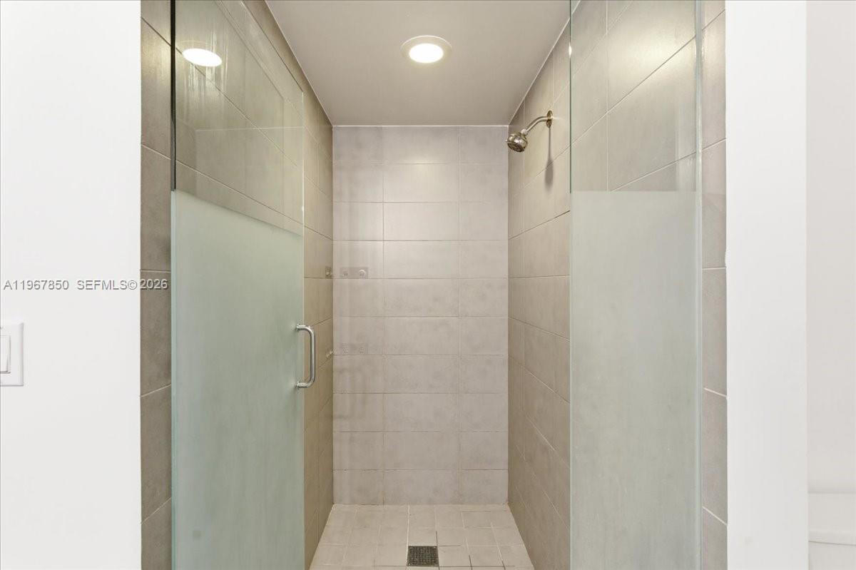 92 Southwest 3rd Street, Unit 3804 Miami, FL 33130 - Photo 21 of 36 a bathroom with a shower and a glass door