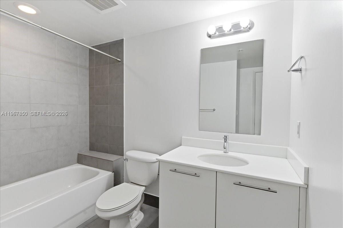 92 Southwest 3rd Street, Unit 3804 Miami, FL 33130 - Photo 27 of 36 a bathroom with a sink a toilet and shower