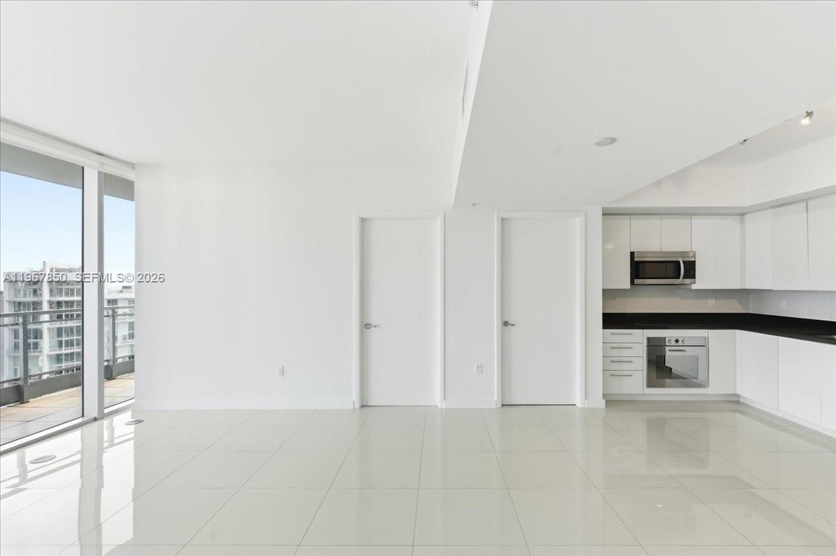 92 Southwest 3rd Street, Unit 3804 Miami, FL 33130 - Photo 5 of 36 a view of kitchen with stainless steel appliances cabinets