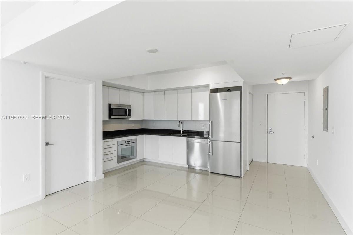 92 Southwest 3rd Street, Unit 3804 Miami, FL 33130 - Photo 8 of 36 a kitchen with stainless steel appliances granite countertop a refrigerator and a sink