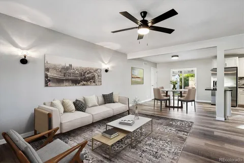 a living room with furniture and wooden floor