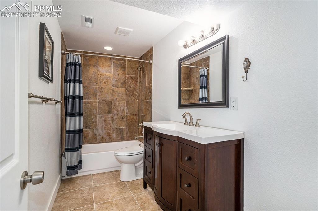 4810 Airport Road Colorado Springs, CO 80916 - Photo 23 of 41 a bathroom with a toilet sink and shower