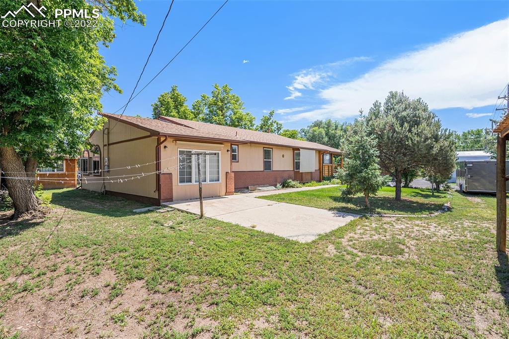 4810 Airport Road Colorado Springs, CO 80916 - Photo 3 of 41 a view of a house with a yard