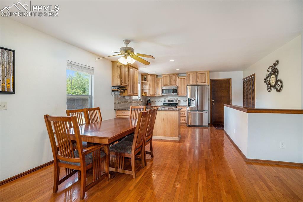 4810 Airport Road Colorado Springs, CO 80916 - Photo 9 of 41 a view of a dining room with furniture window and wooden floor
