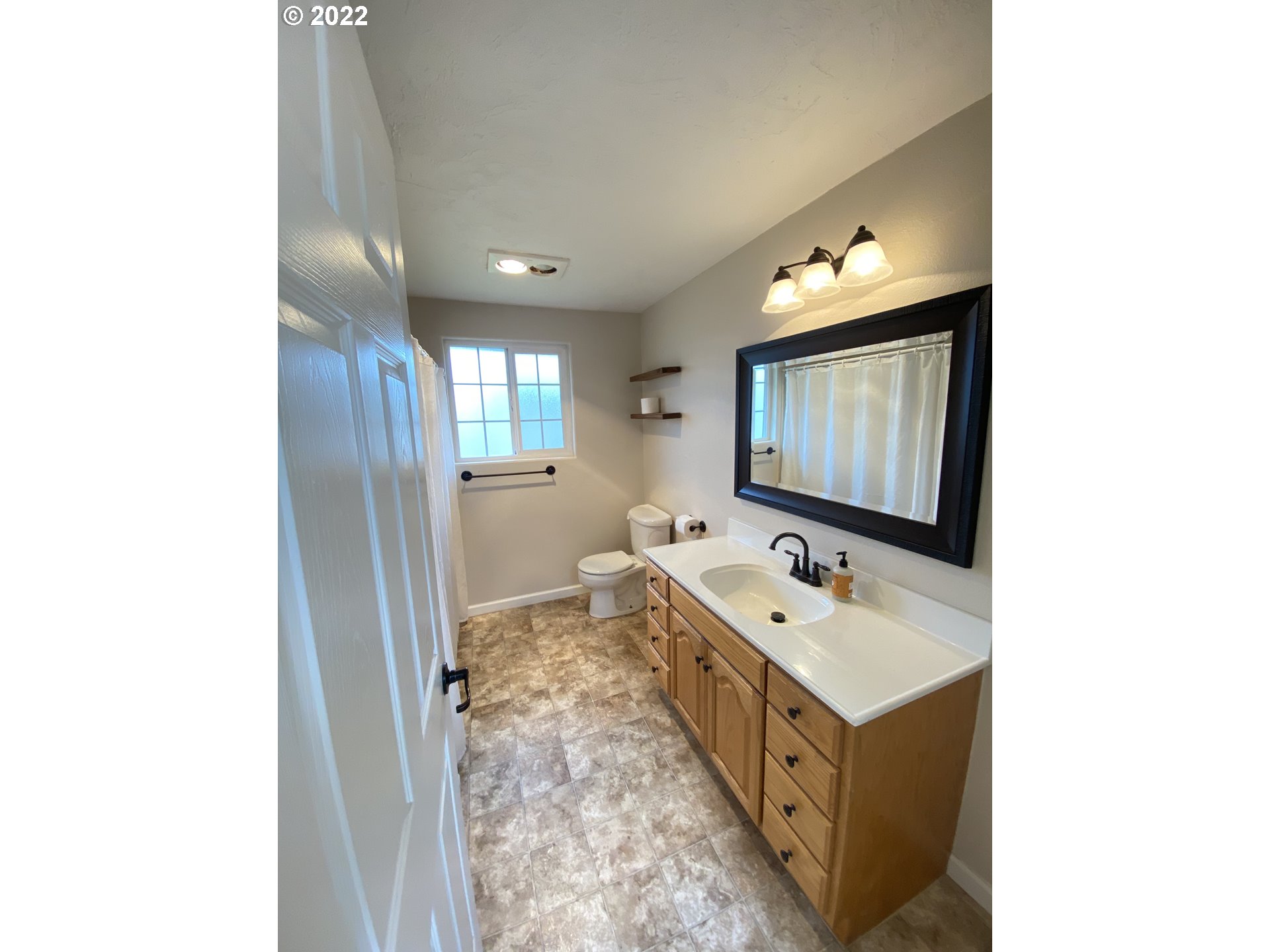 5330 B Street Springfield, OR 97478 - Photo 14 of 28 a bathroom with a sink and a mirror