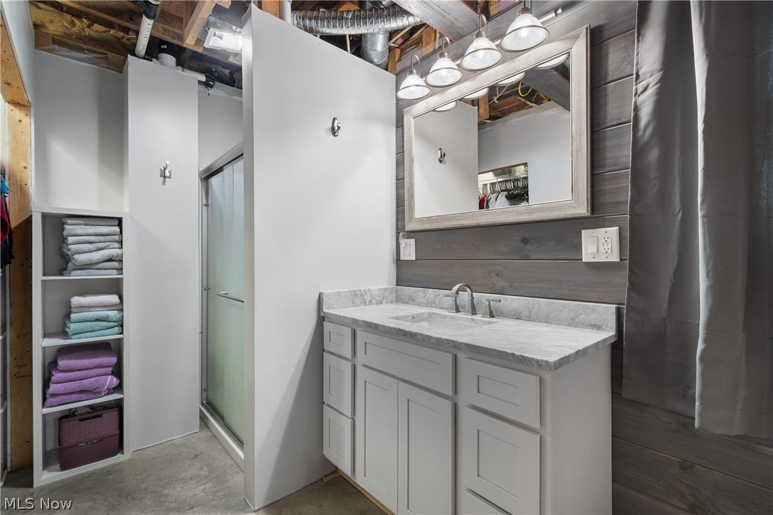29395 Beitler Road Dennison, OH 44621 - Photo 22 of 33 Full bath with a stall shower, vanity, and unfinished concrete flooring