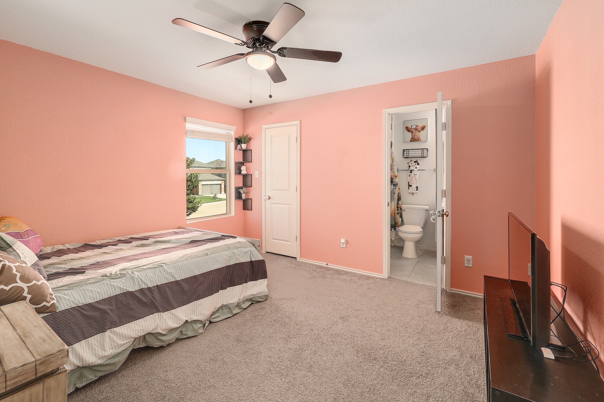735 Circle Way Jarrell, TX 76537 - Photo 20 of 32 A windowed secondary bedroom features plush wall-to-wall carpeting and access to a private bathroom.