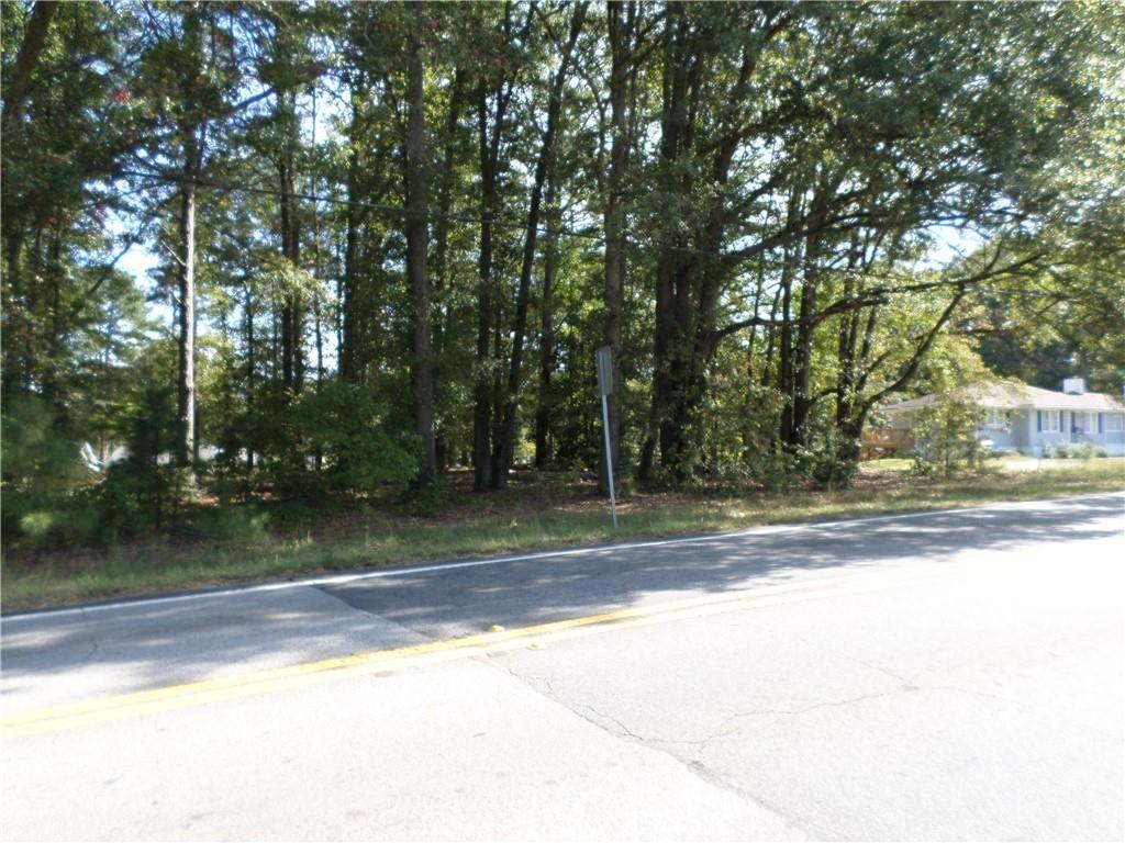 4595 Austell Powder Springs Road Southwest Austell, GA 30106 - Photo 6 of 16 a view of a yard with large trees