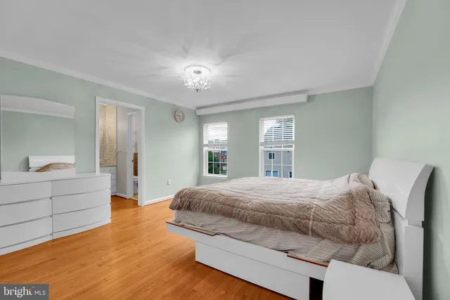 a bedroom with a large bed and window