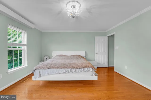 a spacious bedroom with a bed and a window