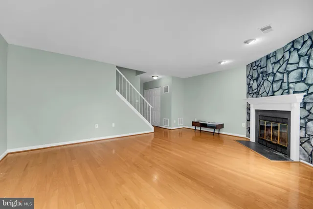 a view of an empty room with a fireplace