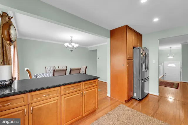 a kitchen with stainless steel appliances granite countertop a refrigerator and a sink