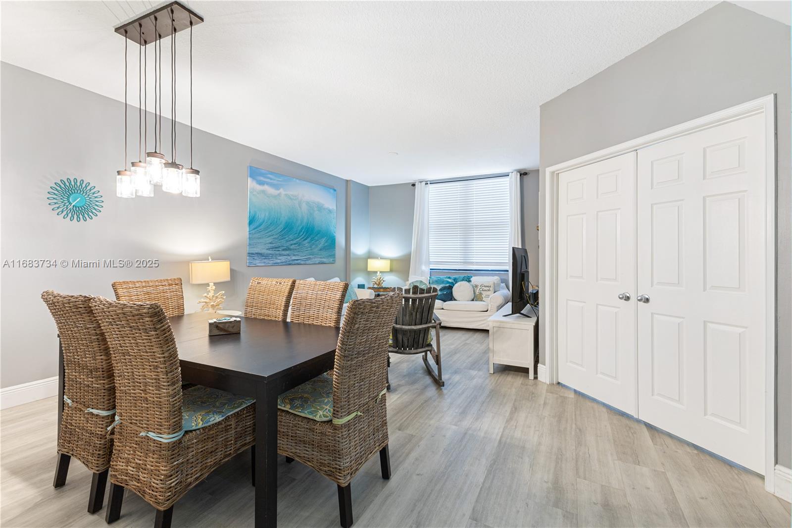 a dining room with furniture a chandelier and wooden floor