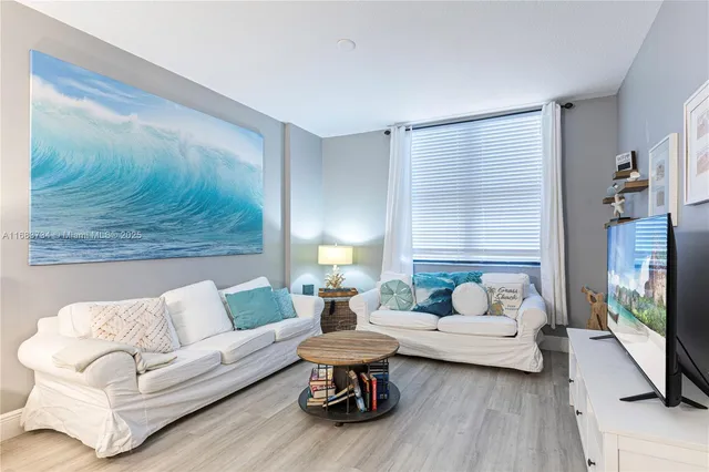 a living room with furniture and a large window