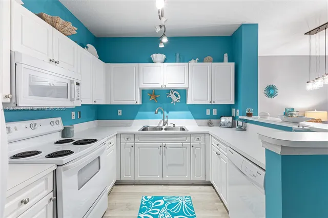 a kitchen with a sink stove and white cabinets