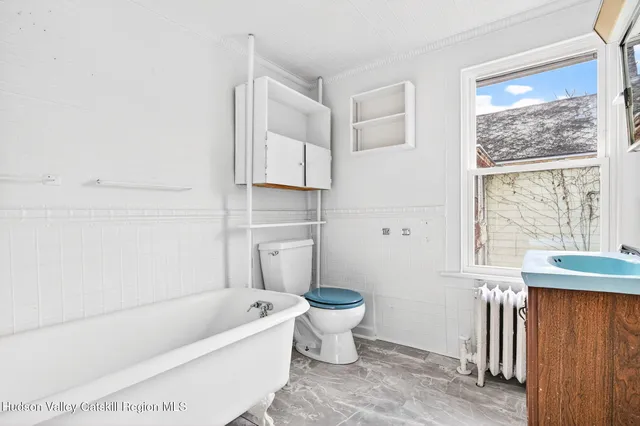 a bathroom with a white bath tub a toilet and a sink