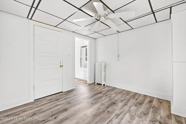a view of a room with wooden floor and windows