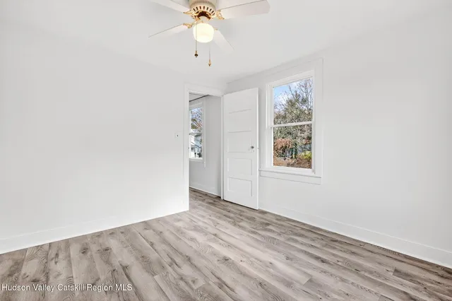 a porch with a bench next to a yard