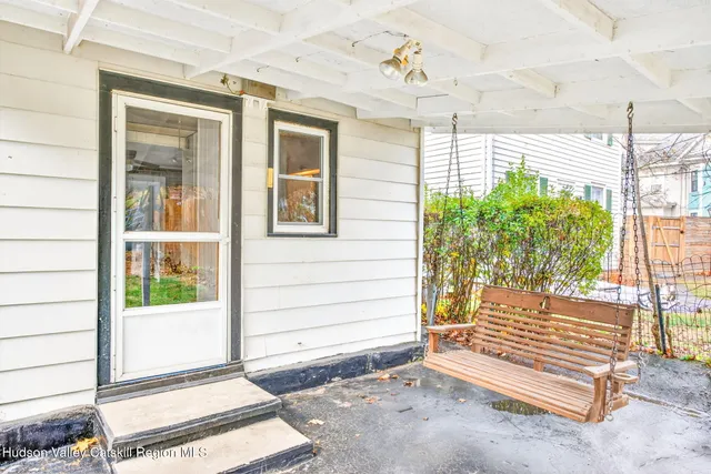 a view of a house with backyard and a tree