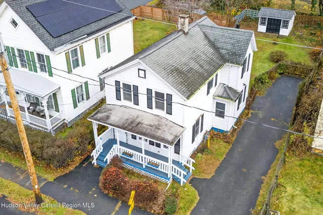 a aerial view of a house with a yard and balcony