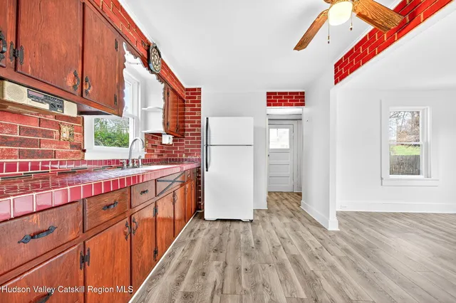 a kitchen with stainless steel appliances granite countertop a refrigerator and a stove top oven
